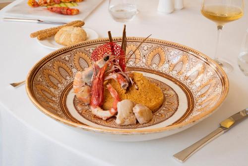 a plate of food with shrimp on a table at Almar Giardino di Costanza Resort & Spa in Mazara del Vallo