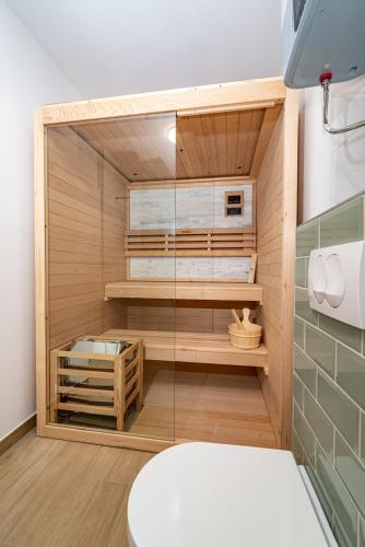 a sauna with a glass door in a room at Villa Helena Rovanjska in Rovanjska