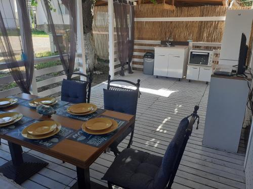 una mesa y sillas en una terraza con cocina en Camping Goldfish en Sozopol