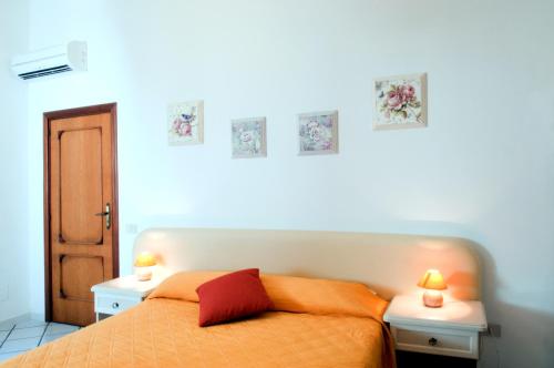 a bedroom with an orange bed and two night stands at Mimì B&B in Ravello