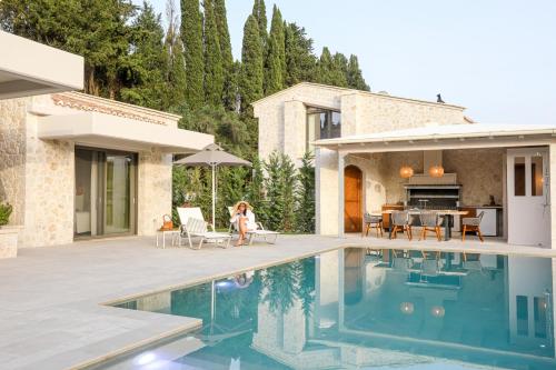 a villa with a swimming pool and a house at My Mediterranean Corfu Luxury Villa with Private Swimming Pool in Kontokali