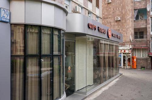 a store front with glass doors on a city street at Good Hotel Yerevan in Yerevan