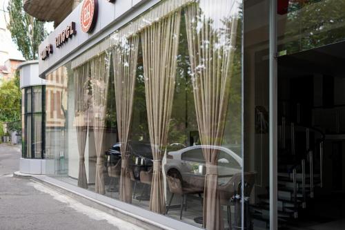 a window of a store with a car in it at Good Hotel Yerevan in Yerevan