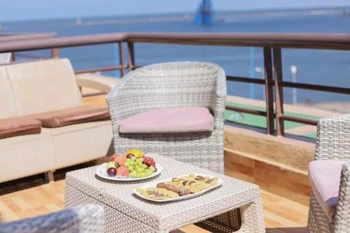 a table with a plate of food on a balcony at Resta Port Said Hotel in Port Said