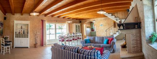 a living room with blue and white striped chairs at Villa Pavicini 2181 in Šegotići