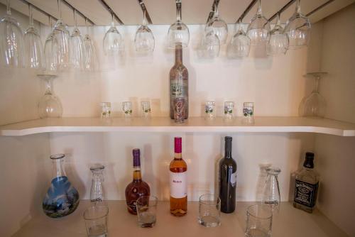 a bunch of wine bottles and glasses on a shelf at Villa Pavicini 2181 in Šegotići