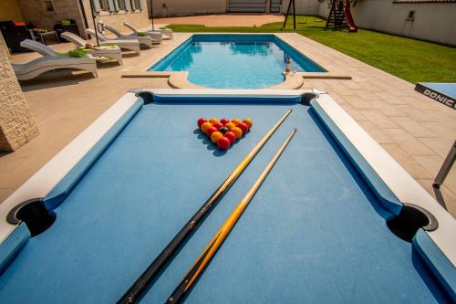 a pool table with balls on top of it at Villa Pavicini 2181 in Šegotići