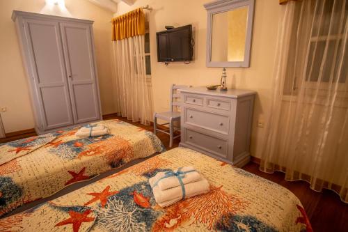 a bedroom with two beds and a dresser and a tv at Villa Pavicini 2181 in Šegotići