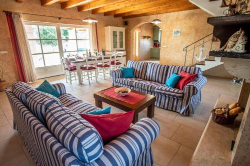 a living room with blue and white striped couches at Villa Pavicini 2181 in Šegotići