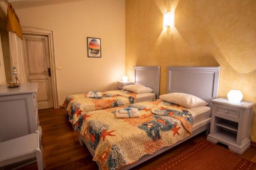 a bedroom with two beds and two night stands at Villa Pavicini 2181 in Šegotići