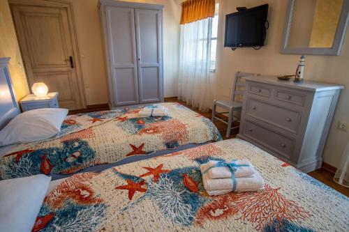 a bedroom with two beds and a television in it at Villa Pavicini 2181 in Šegotići