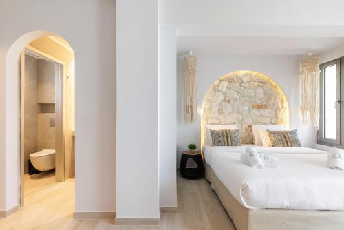 Ένα ή περισσότερα κρεβάτια σε δωμάτιο στο Amalthia Luxury Suites