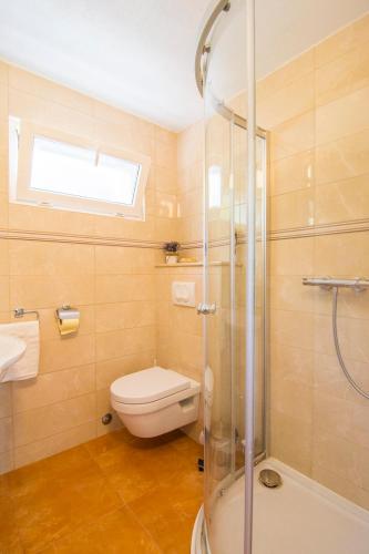 a bathroom with a shower and a toilet and a sink at Beach House Splitska in Splitska