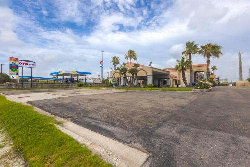 an empty parking lot in front of a gas station at Coastal Inn Corpus Christi in Corpus Christi