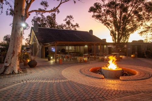 a fire pit in a courtyard in front of a building at Inverdoorn Game Reserve Lodge in Breede River DC