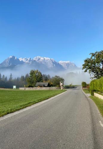 an empty road with mountains in the background at Bauernhof Lehengut in Pfarrwerfen