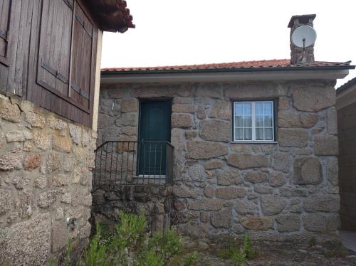a stone building with a door and a window at Casa de Fundevila in Campo do Gerês