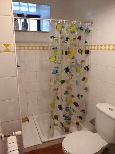 a bathroom with a shower curtain with fish on it at Casa de Fundevila in Campo do Gerês