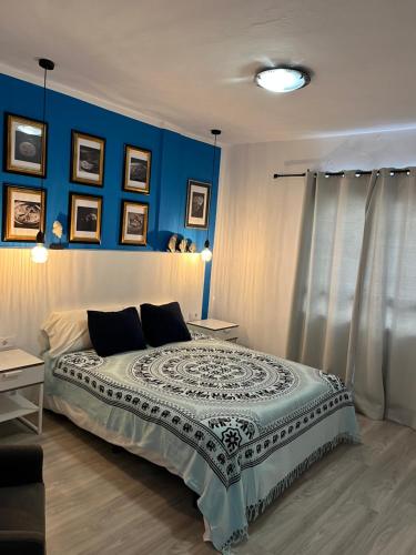 a bedroom with a large bed with blue walls at CORNELIAS HOME TC1 playa in Los Cristianos