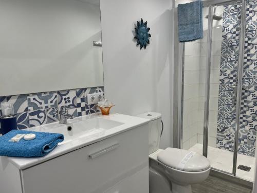 a bathroom with a sink and a toilet and a shower at CORNELIAS HOME TC1 vista marina in Los Cristianos