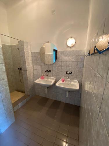 a bathroom with two sinks and a mirror and a shower at Chata Botas in Strážné