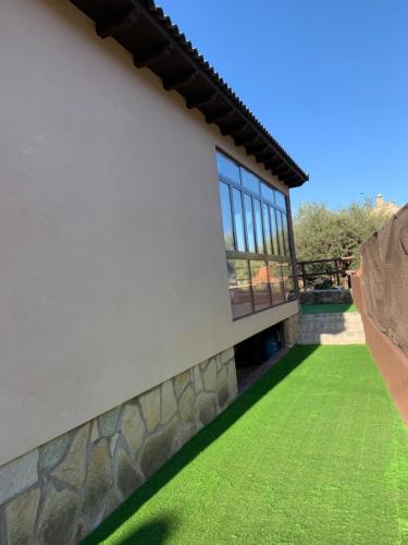 a rendering of a house with a green lawn at El Refugio de Felix in Sotillo de la Adrada