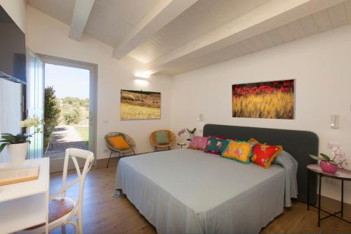 a bedroom with a bed and a table and chairs at Casale Oliveta in Orbetello