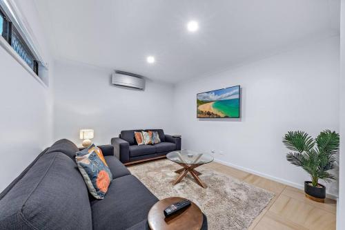 a living room with a couch and a table at Airlie Beach Home in Airlie Beach