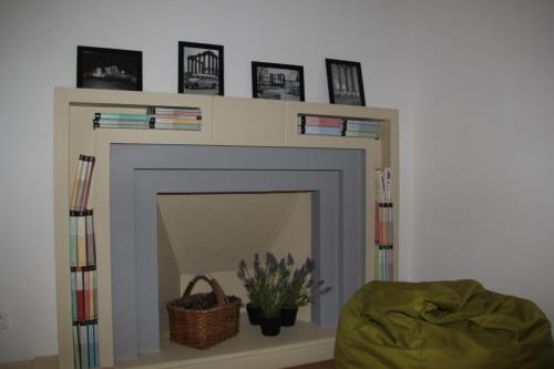 a living room with a fireplace with a mirror at StayInn City - Évora in Évora
