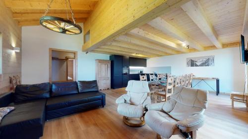 a living room with a couch and two chairs at Chalet des Alpes NATURE & MOUNTAIN by Alpvision Résidences in Prarion