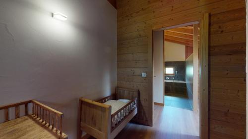 a room with two wooden stairs and a hallway at Chalet des Alpes NATURE & MOUNTAIN by Alpvision Résidences in Prarion