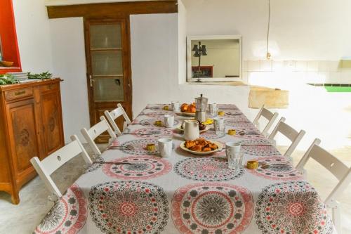 a dining room table with plates of food on it at Casa Bienvenida - Carcaixent in Carcagente