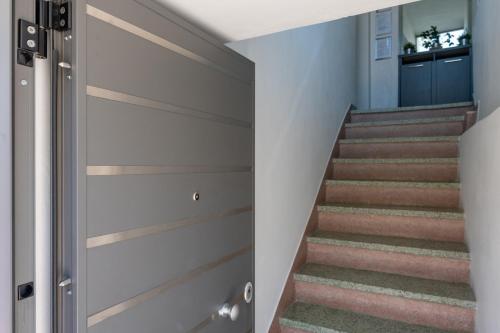 a staircase with wooden sliding doors in a house at Greenhouse - Kalamata Mediterranean Villas in Kalamata