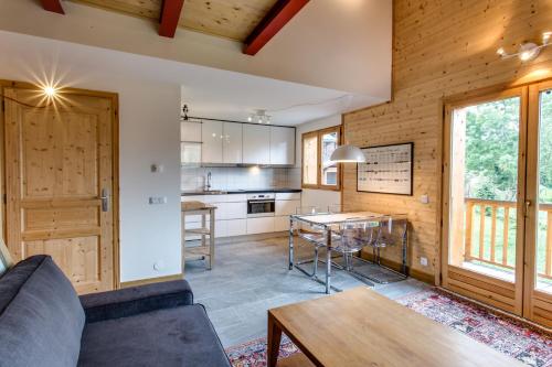 a living room with a couch and a table at Apartment Chalet des Granges in Les Houches