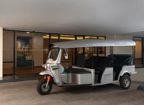 a golf cart parked in front of a building at Citadines Sukhumvit 8 Bangkok in Bangkok