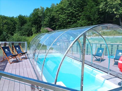 a swimming pool with a glass dome on a boat at DobraNocka in Małastów