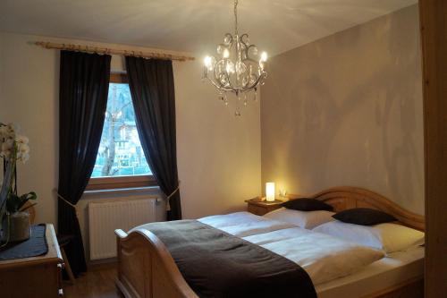 a bedroom with a bed and a chandelier at Haus Maiern in Ridanna