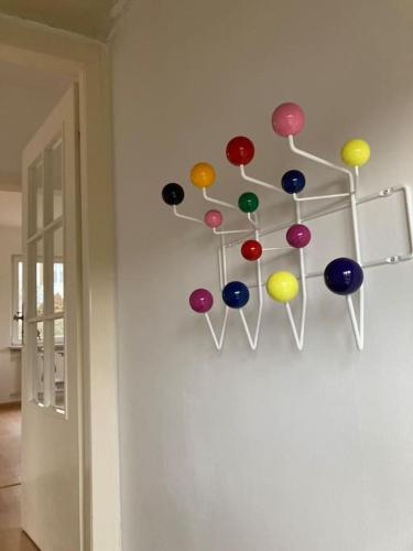 a bunch of colorful buttons hanging on a wall at Villa Rosa in Bad Sachsa
