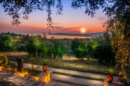 a sunset view from the garden of a villa at Kallisti Hotel in Potos
