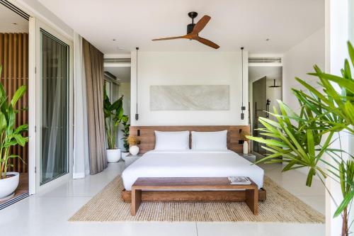 a bedroom with a bed and a ceiling fan at Anaia in Thongsala