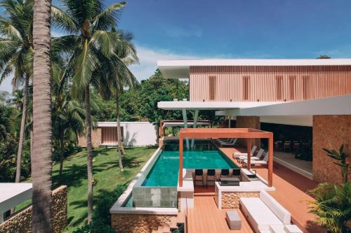 an aerial view of a house with a swimming pool at Anaia in Thongsala