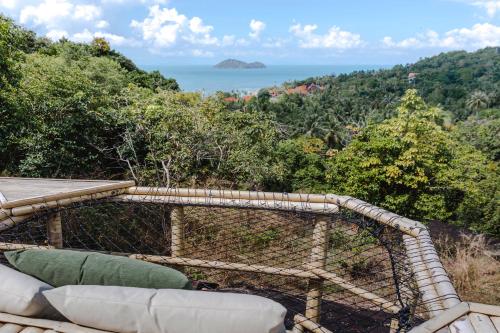 a balcony with a view of the ocean at Anaia in Thongsala
