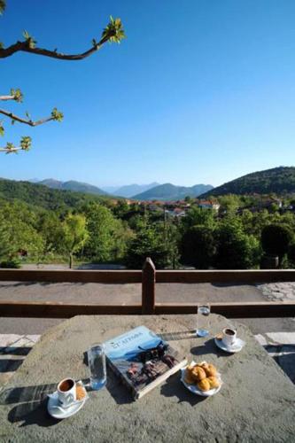 a table with a plate of food on top of it at Hotel Makkas in Kréntis