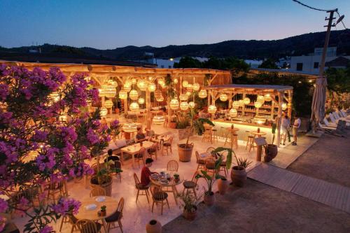 an overhead view of a patio with tables and chairs and flowers at Faros Bodrum Hotel - Special Category in Golturkbuku