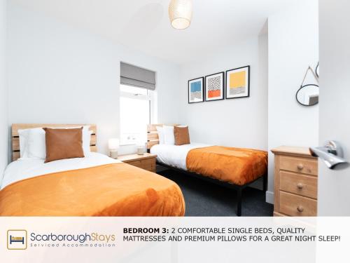 a bedroom with two beds and a dresser and a bed sidx sidx sidx sidx at Scarborough Stays - Trafalgar Lodge - 4 bedroomed house - Free Parking in Scarborough