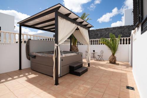 a gazebo on the patio of a house at Villa Carolina in Tías