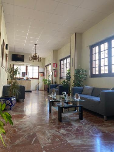 a large living room with couches and tables at Hotel Medina Centro in Jerez de la Frontera