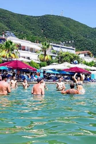 a group of people in the water at a beach at menidistudios in Menídion