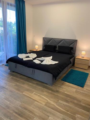 a bedroom with a bed with a black comforter at Studio PAMI in St. St. Constantine and Helena