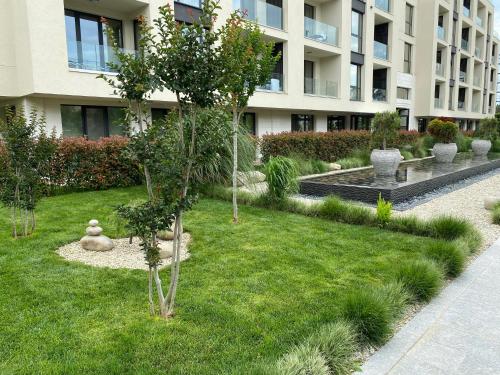 a garden in front of a building with trees and plants at Studio PAMI in St. St. Constantine and Helena
